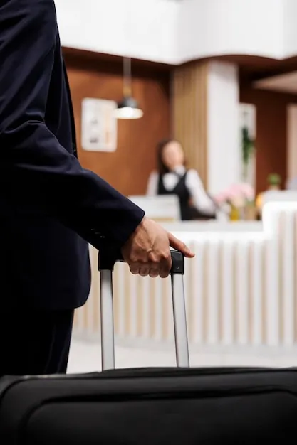 Business traveller speaking with a receptionist on arrival